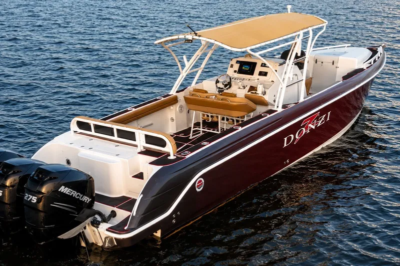Slide: The Image of 2006 Donzi 38 ZFX Cuddy boat with twin Mercury engines on open water. - 16