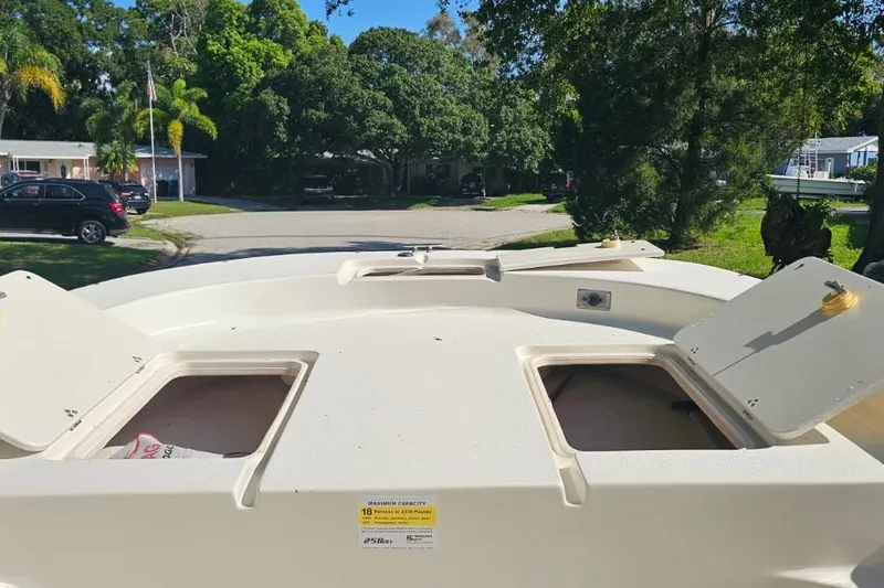 Slide: The Image of 2016 Carolina Skiff 258 DLV boat deck with open storage compartments. - 6