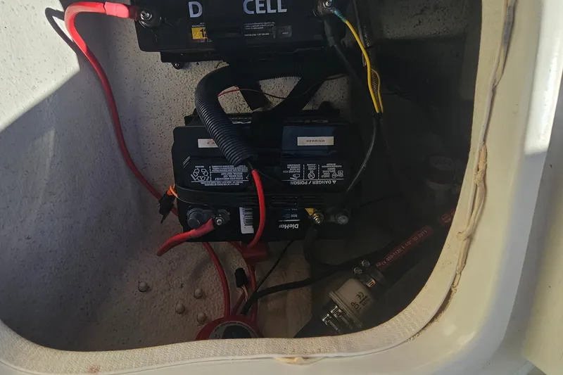 Slide: The Image of Battery compartment of a 2016 Carolina Skiff 258 DLV boat with wiring connections. - 19