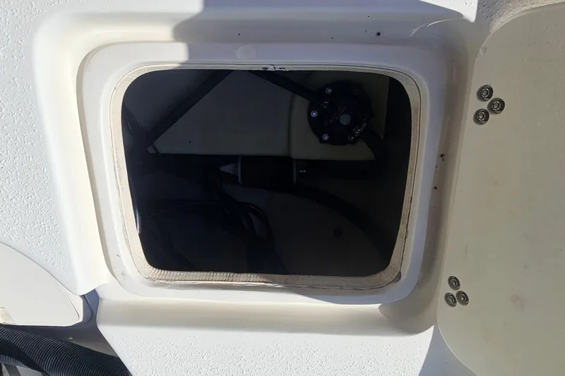 Slide: The Image of Open hatch on a 2016 Carolina Skiff 258 DLV boat, showing interior compartment. - 22