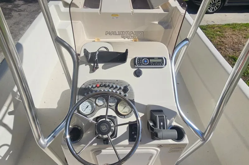 Slide: The Image of 2016 Carolina Skiff 258 DLV boat console with steering wheel and controls. - 10