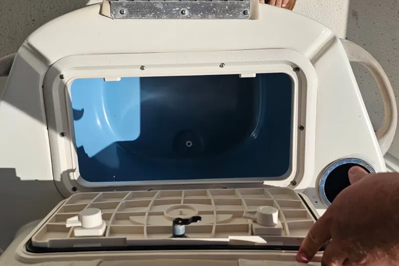Slide: The Image of Open storage compartment on a 2016 Carolina Skiff 258 DLV boat. - 9