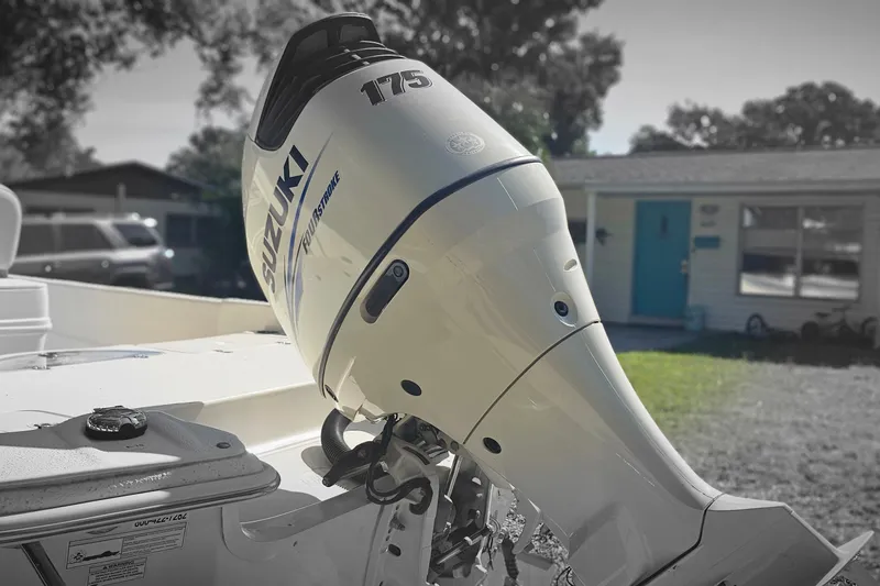 Slide: The Image of 2016 Carolina Skiff 258 DLV with Suzuki 175 outboard motor in residential setting. - 20