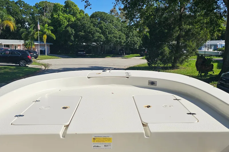 Slide: The Image of 2016 Carolina Skiff 258 DLV boat deck in a suburban neighborhood setting. - 5