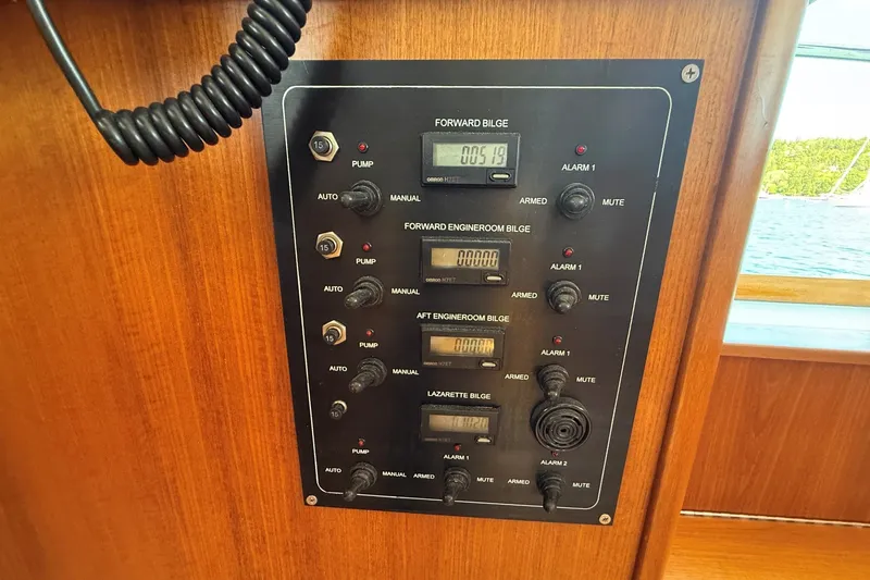 Slide: The Image of Control panel of a 2013 York's Marine 46 Flybridge Cruiser, featuring bilge pump switches. - 58
