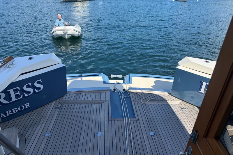 Slide: The Image of York's Marine 46 Flybridge Cruiser 2013, view from deck with inflatable boat nearby. - 26