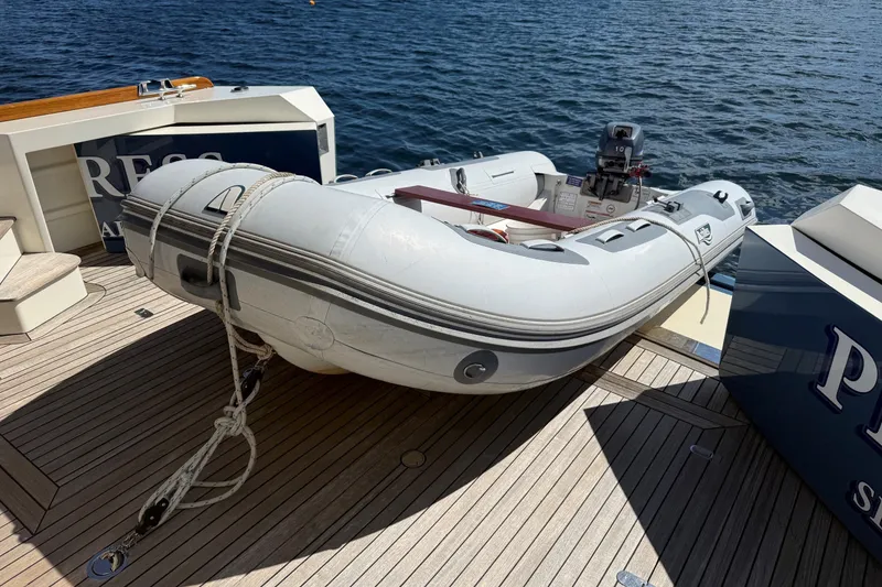 Slide: The Image of Inflatable boat on York's Marine 46 Flybridge Cruiser, 2013, docked on wooden deck. - 30
