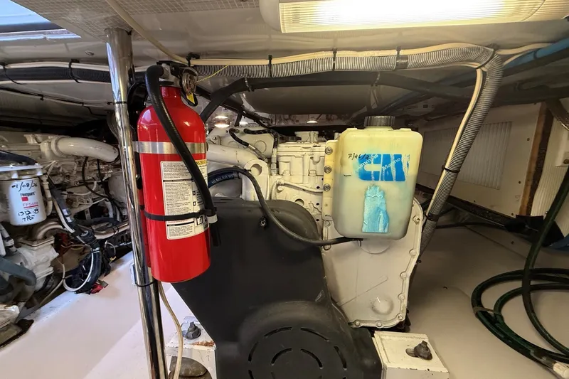 Slide: The Image of Engine room of 2013 York's Marine 46 Flybridge Cruiser with fire extinguisher and coolant tank. - 71