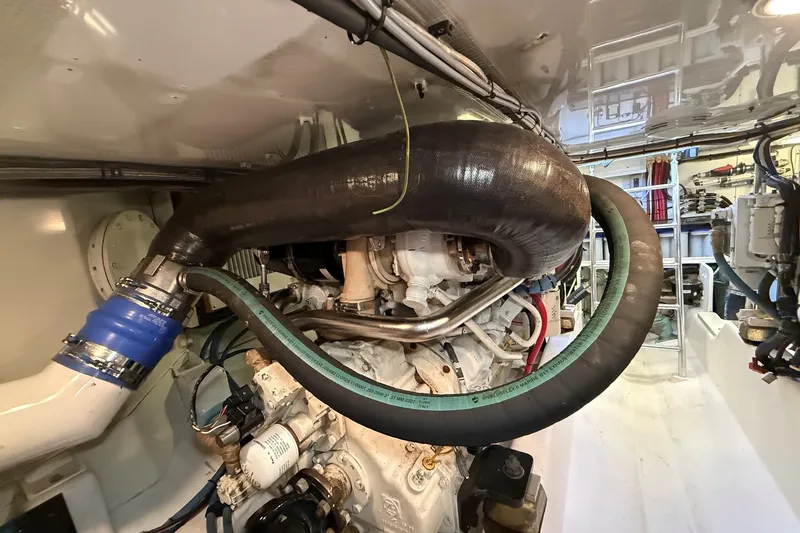 Slide: The Image of Engine room of 2013 York's Marine 46 Flybridge Cruiser, showcasing complex piping and machinery. - 70