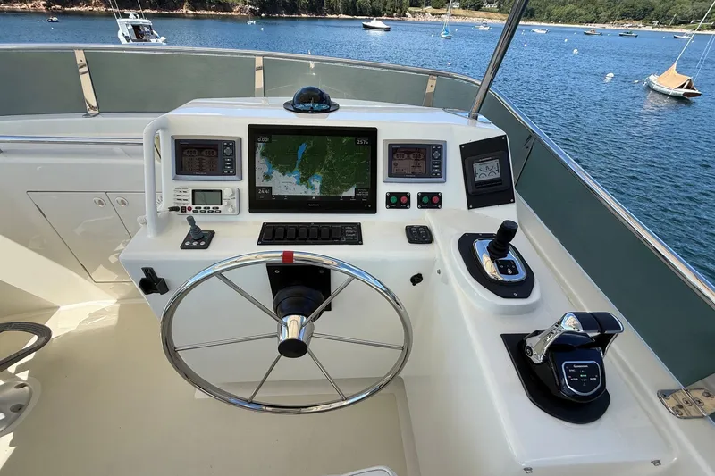 Slide: The Image of Flybridge helm of 2013 York's Marine 46 Cruiser with navigation controls and scenic water view. - 19