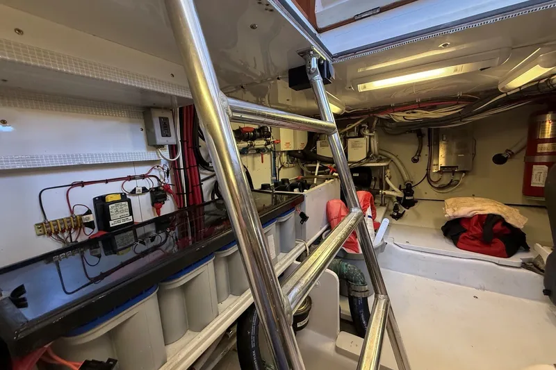 Slide: The Image of Engine room of 2013 York's Marine 46 Flybridge Cruiser with ladder and equipment. - 61