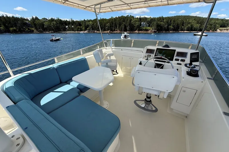 Slide: The Image of Flybridge of 2013 York's Marine 46 Cruiser with seating, helm, and scenic water view. - 22
