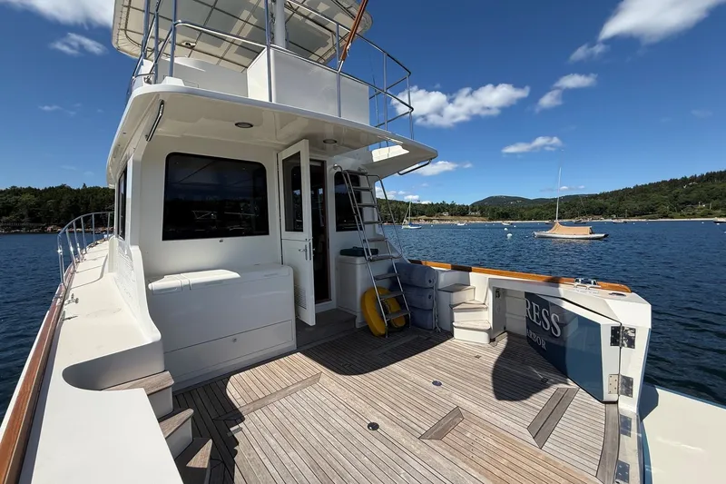 Slide: The Image of York's Marine 46 Flybridge Cruiser 2013 on serene water with scenic backdrop. - 9
