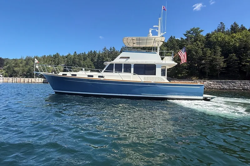 Slide: The Image of 2013 York's Marine 46 Flybridge Cruiser on scenic waterway with forested background. - 6