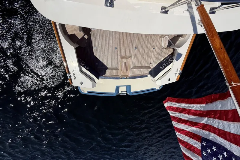Slide: The Image of Overhead view of 2013 York's Marine 46 Flybridge Cruiser with American flag on water. - 20