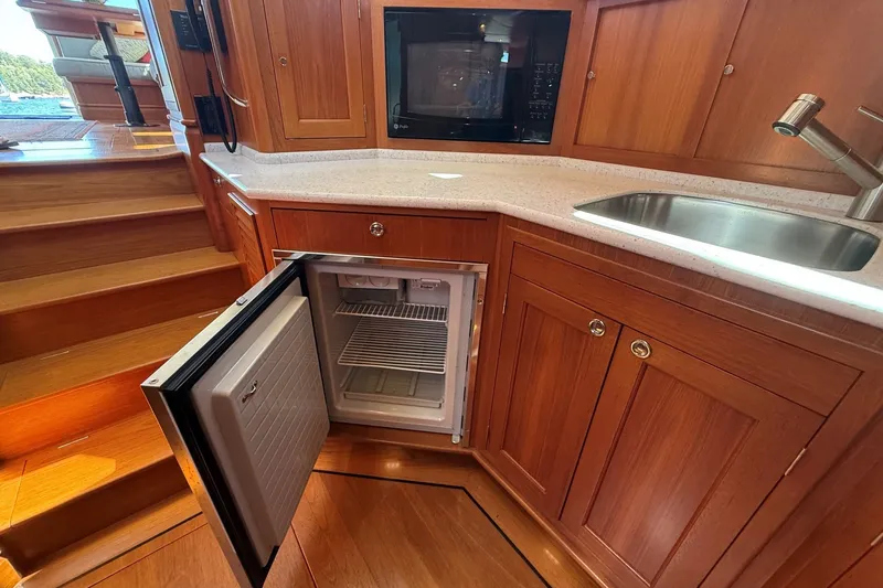 Slide: The Image of Luxurious kitchen area in 2013 York's Marine 46 Flybridge Cruiser with open fridge. - 49