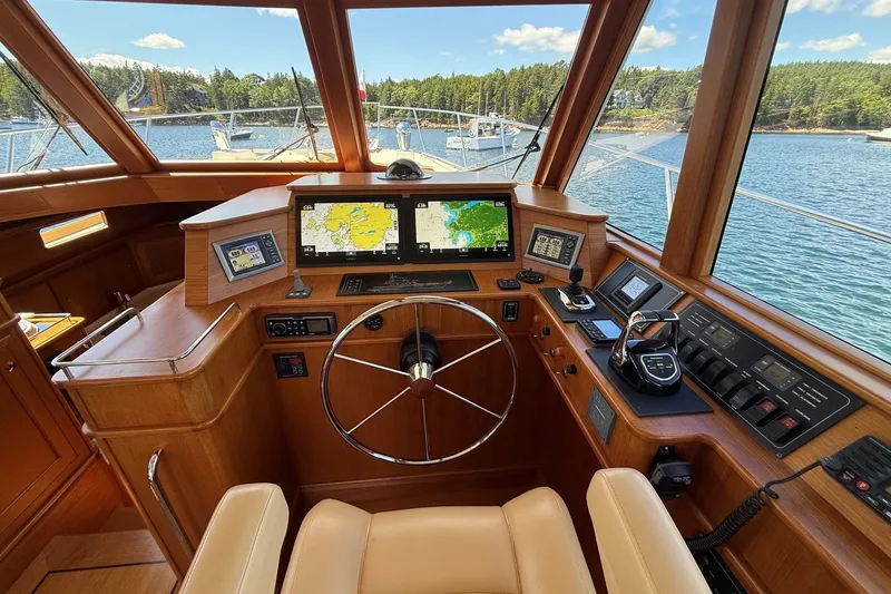 Slide: The Image of Luxurious helm of 2013 York's Marine 46 Flybridge Cruiser with navigation screens and controls. - 38