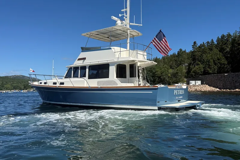 Slide: The Image of 2013 York's Marine 46 Flybridge Cruiser on water, American flag, scenic background. - 7