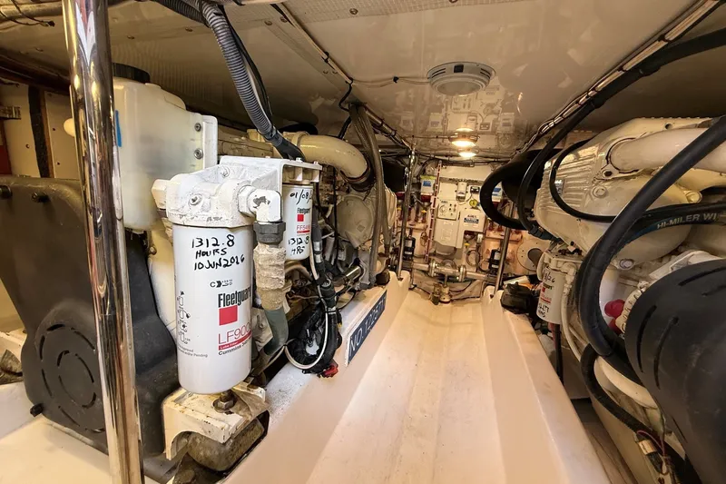 Slide: The Image of Engine room of 2013 York's Marine 46 Flybridge Cruiser, showcasing mechanical components and filters. - 63