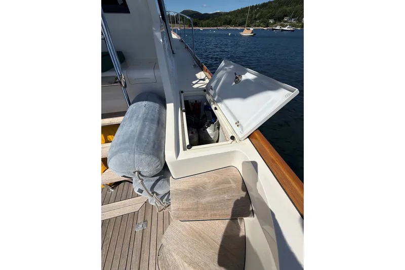 Slide: The Image of 2013 York's Marine 46 Flybridge Cruiser deck with open storage compartment. - 14