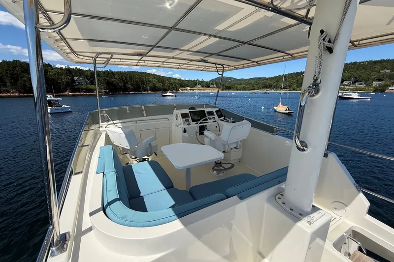 Slide: The Image of Flybridge of 2013 York's Marine 46 Cruiser with seating and helm, overlooking scenic waters. - 18