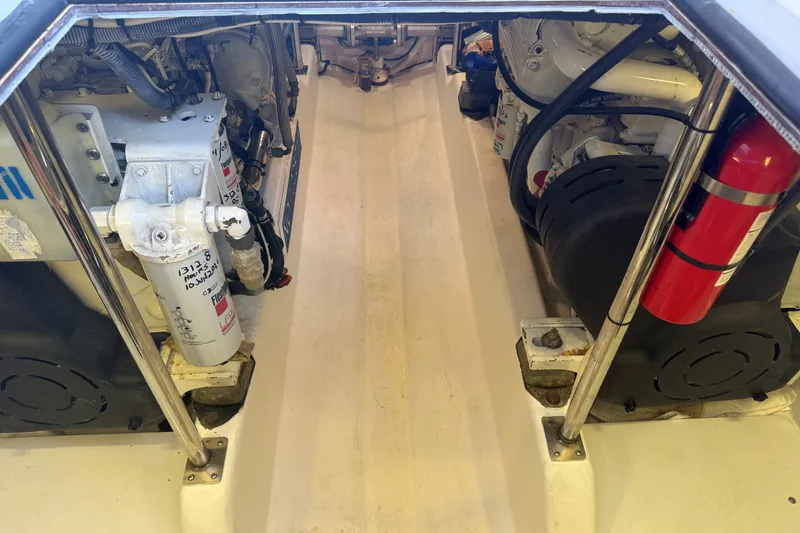 Slide: The Image of Engine compartment of 2013 York's Marine 46 Flybridge Cruiser, featuring dual engines and fire extinguisher. - 65