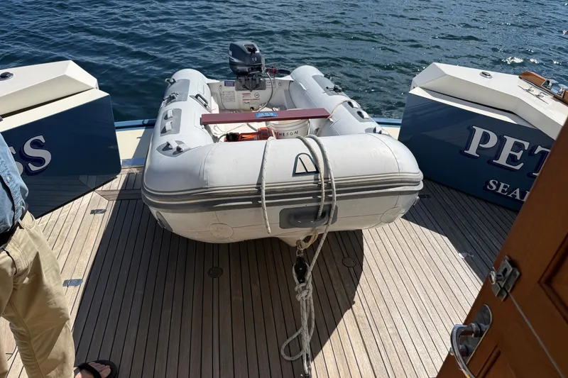 Slide: The Image of York's Marine 46 Flybridge Cruiser 2013 with inflatable dinghy on deck, docked by the sea. - 29