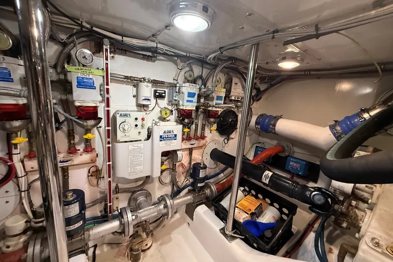 Slide: The Image of Engine room of 2013 York's Marine 46 Flybridge Cruiser, showcasing complex machinery and piping. - 67