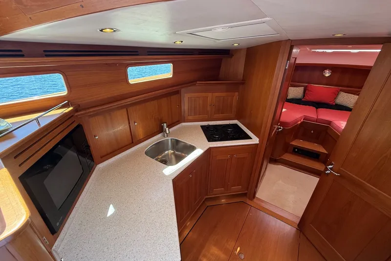 Slide: The Image of Luxurious 2013 York's Marine 46 Flybridge Cruiser interior with kitchen and cozy cabin. - 42