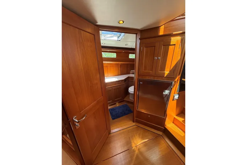 Slide: The Image of Interior of 2013 York's Marine 46 Flybridge Cruiser with wooden cabinetry and compact bathroom. - 47