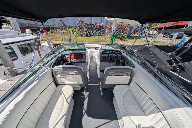 Slide: The Image of 2006 Cobalt 262 boat interior with white seating and dashboard view. - 10