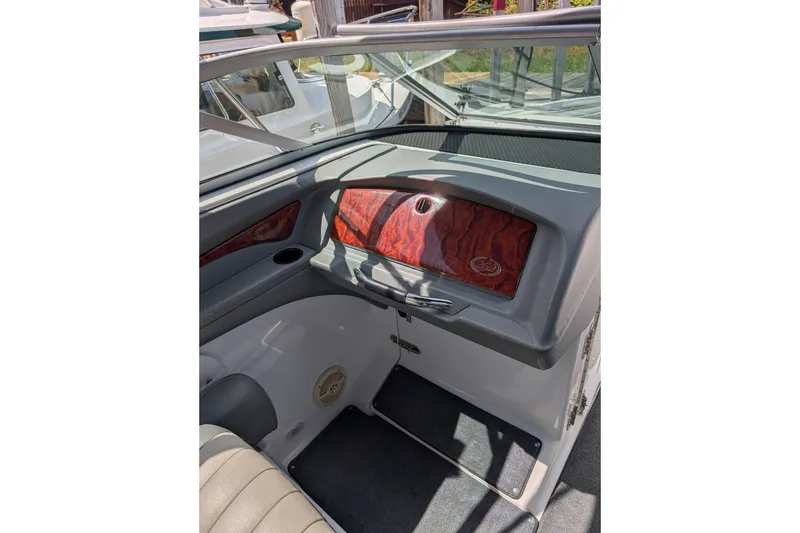 Slide: The Image of Interior of a 2006 Cobalt 262 boat with wood paneling and seating. - 6