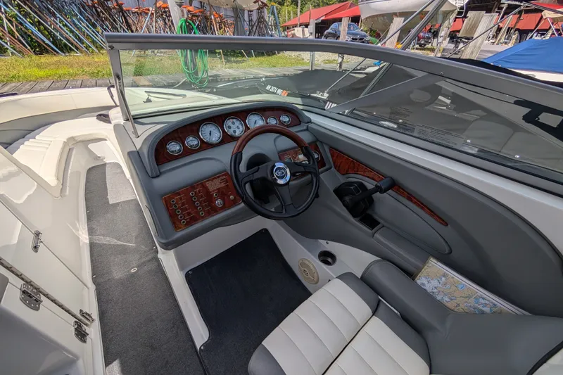 Slide: The Image of Interior of a 2006 Cobalt 262 boat, featuring a sleek dashboard and steering wheel. - 3