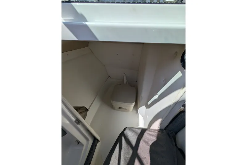Slide: The Image of Interior cabin of a 2006 Cobalt 262 boat, featuring a compact toilet. - 7