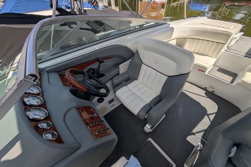 Slide: The Image of Interior of a 2006 Cobalt 262 boat with steering wheel and seating. - 1