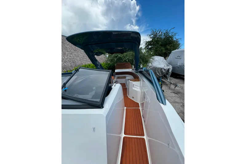 Slide: The Image of 2025 NX Boats NX280 XTREME with sleek deck design and modern features. - 14