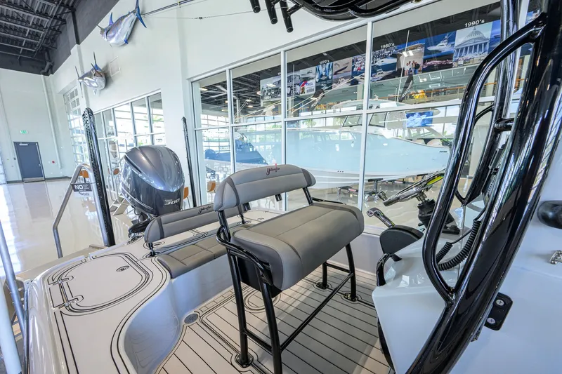 Slide: The Image of 2017 Yellowfin 24 Bay CE boat interior with seating and Yamaha engine in showroom. - 39