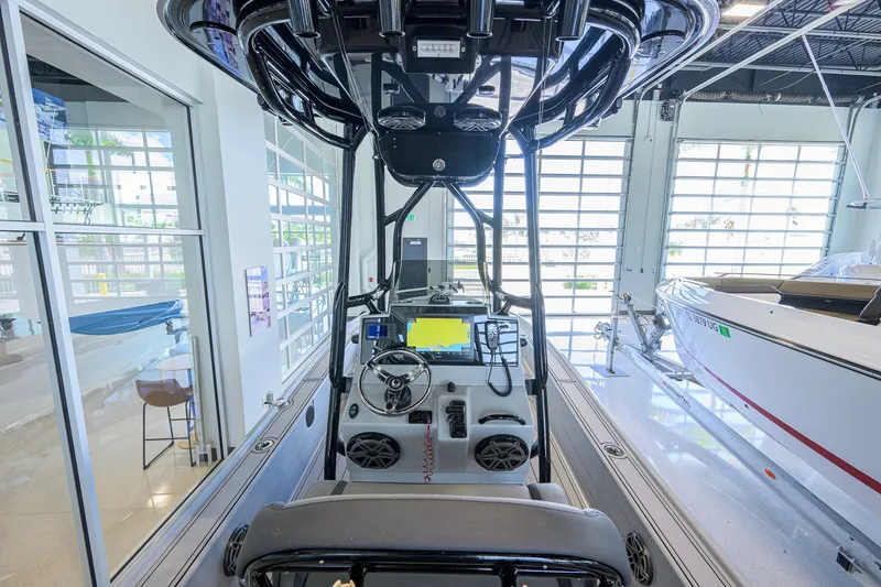 Slide: The Image of 2017 Yellowfin 24 Bay CE boat interior with advanced navigation equipment in showroom. - 7
