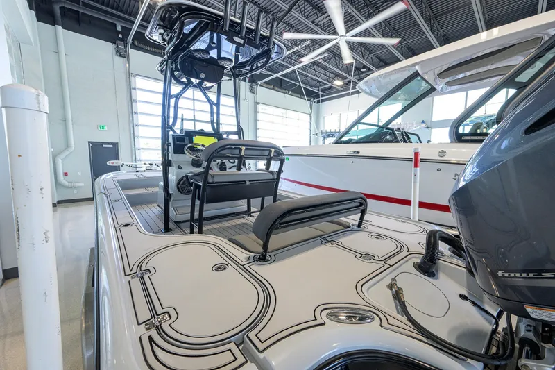 Slide: The Image of 2017 Yellowfin 24 Bay CE boat in showroom, featuring sleek design and modern equipment. - 27
