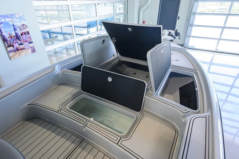 Slide: The Image of 2017 Yellowfin 24 Bay CE boat interior with open storage compartments. - 20