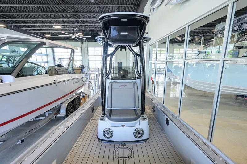 Slide: The Image of 2017 Yellowfin 24 Bay CE boat displayed in a showroom with sleek interior design. - 22