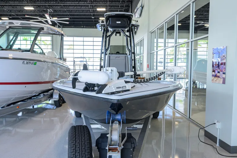 Slide: The Image of 2017 Yellowfin 24 Bay CE boat displayed in a showroom, front view. - 3