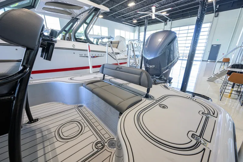 Slide: The Image of 2017 Yellowfin 24 Bay CE boat interior with seating and powerful outboard motor. - 32