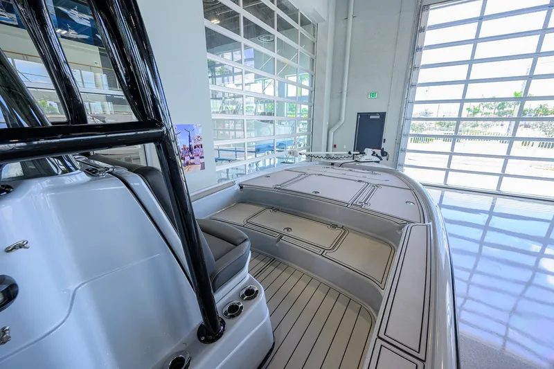 Slide: The Image of 2017 Yellowfin 24 Bay CE boat interior in showroom with sleek design and ample seating. - 18