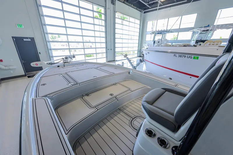 Slide: The Image of 2017 Yellowfin 24 Bay CE boat in showroom, featuring sleek design and spacious deck. - 11