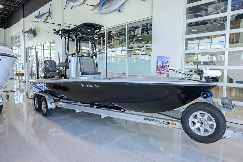 The Image of 2017 Yellowfin 24 Bay CE boat on trailer in showroom, sleek black design. - 0
