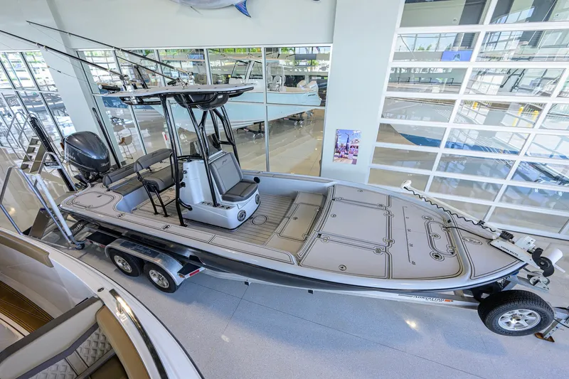 Slide: The Image of 2017 Yellowfin 24 Bay CE boat displayed indoors on a trailer. - 6
