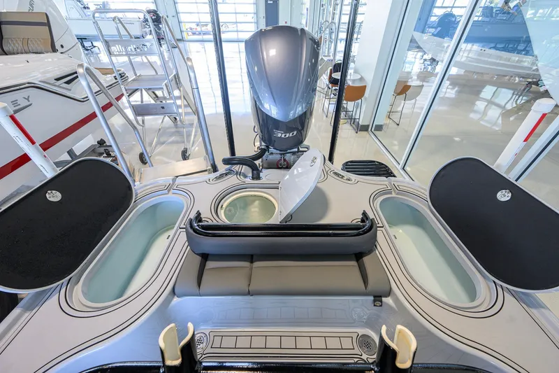 Slide: The Image of 2017 Yellowfin 24 Bay CE boat interior with open compartments and powerful engine. - 34