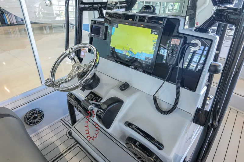 Slide: The Image of 2017 Yellowfin 24 Bay CE boat dashboard with steering wheel and navigation system. - 26