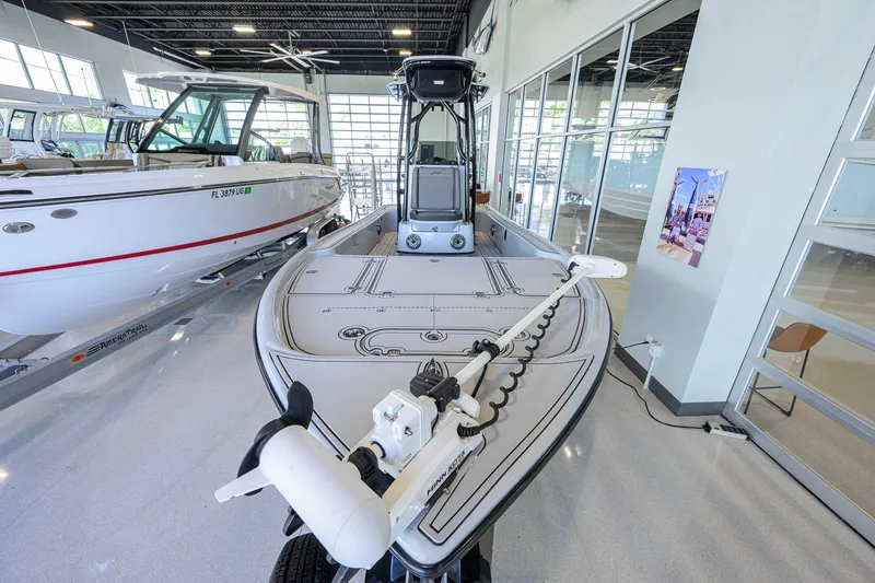 Slide: The Image of 2017 Yellowfin 24 Bay CE boat displayed in a showroom with modern interior. - 4